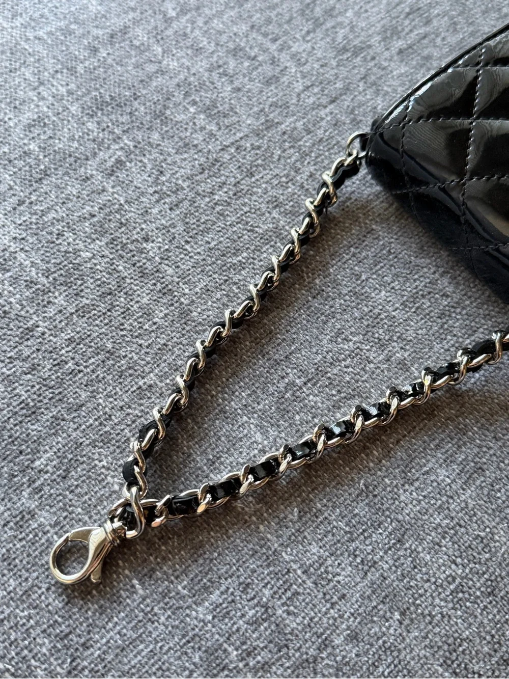 CHANEL Black Patent Leather Quilted Phone Case with Silver Hardware